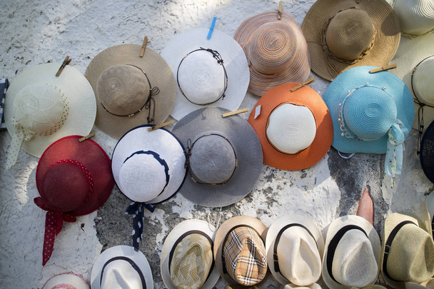 Weergave van een reeks van hoeden opknoping van een muur in de straat - Foto, afbeelding
