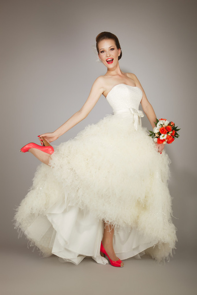 happy bride holding heel - Фото, изображение