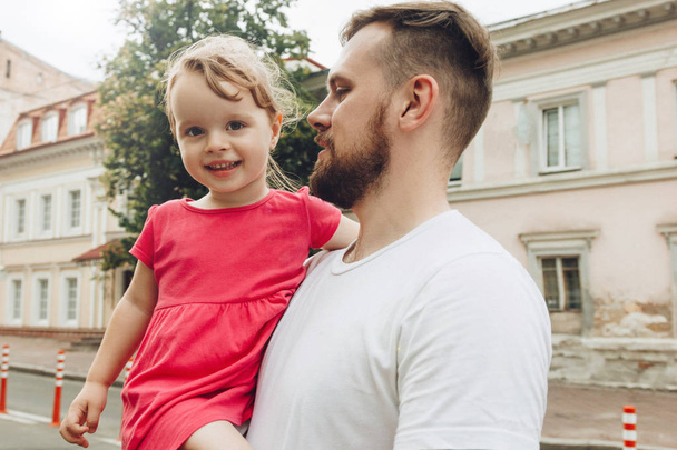 Handsome father holding little daughter - Fotografie, Obrázek