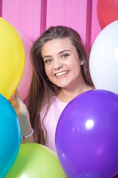 Close up portrait of beautiful young woman with colorful balloons. - Φωτογραφία, εικόνα