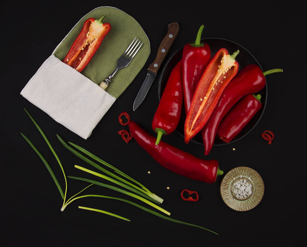 Fresh red pepper on black table - Valokuva, kuva
