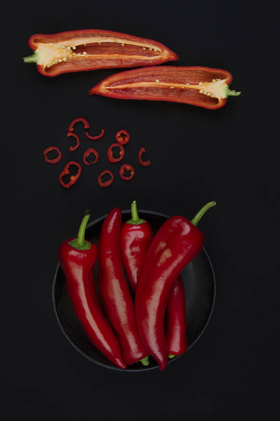 Fresh red pepper on black table  - Foto, afbeelding