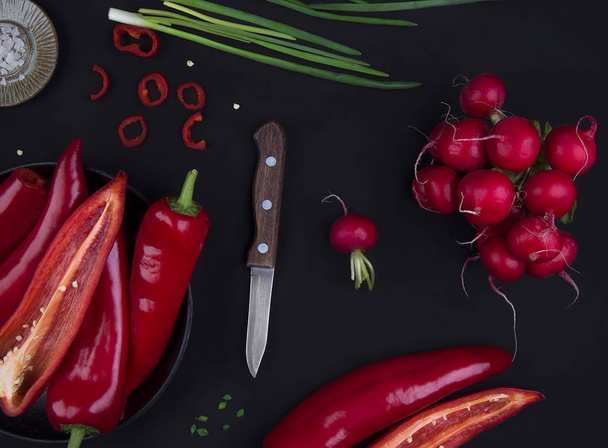 Fresh red pepper on black table - Zdjęcie, obraz