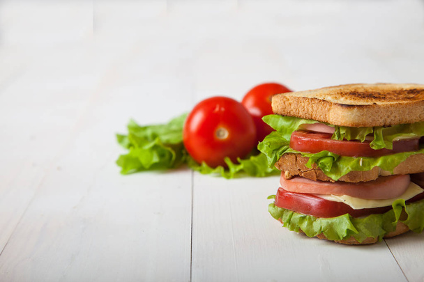 sandwich, tomato, toast, salad  on white wooden background - Foto, Imagem
