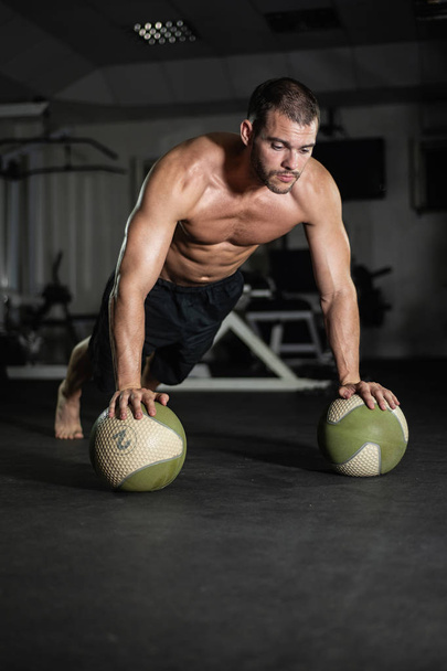 Fitness man does push-ups on the balls, workout lifestyle concept - Foto, Imagen
