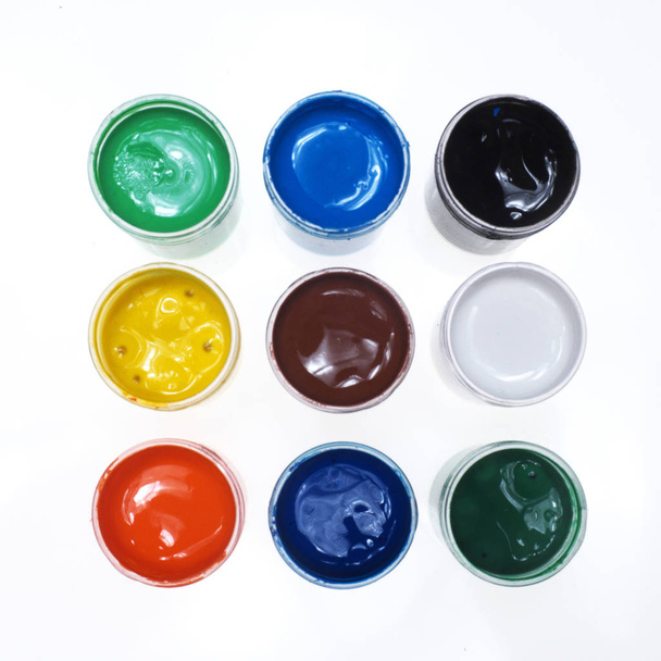 Paints, nine jars with colorful paints on a white background ...  - Foto, afbeelding