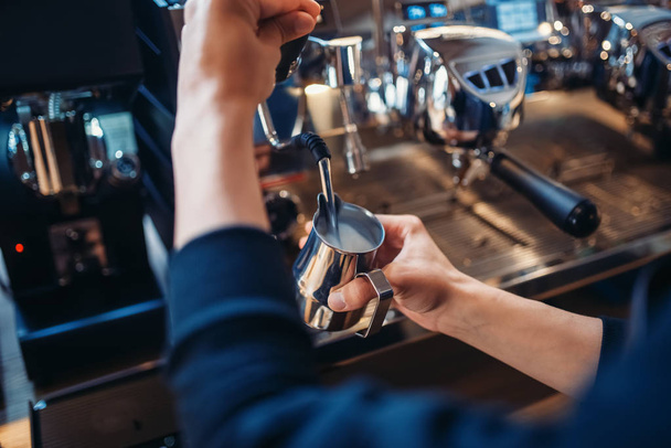 Male barista prepares beverage on coffee machine in cafe. Professional espresso preparation by barman - Photo, Image