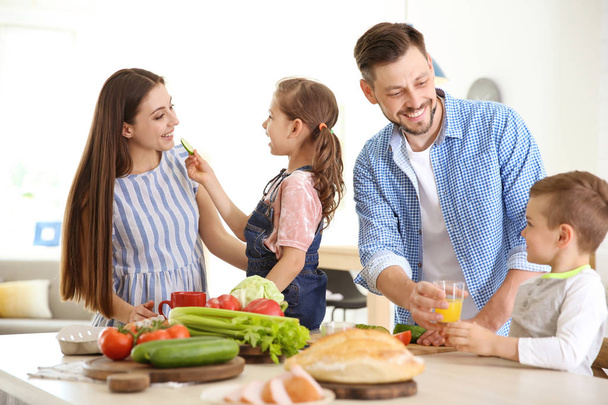 Happy family with children having breakfast in kitchen - Photo, image