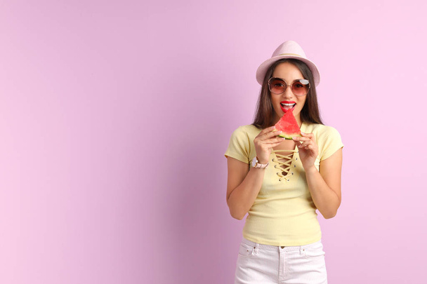 Beautiful young woman posing with watermelon on color background - Zdjęcie, obraz