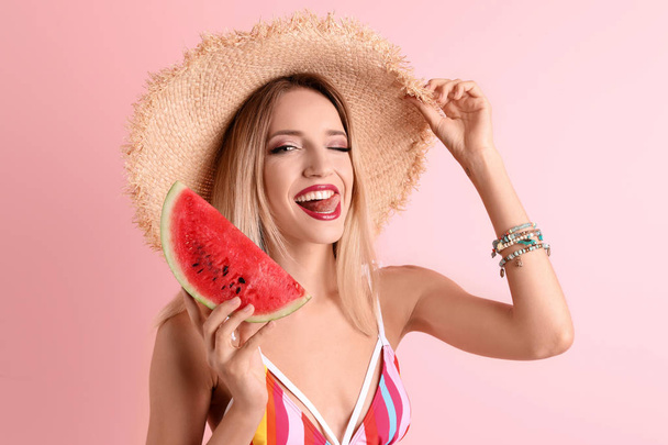 Pretty young woman with juicy watermelon on color background - Photo, image