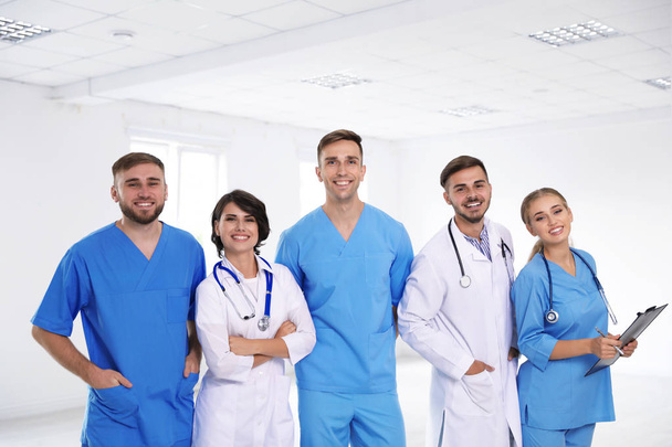 Team of doctors in uniform at workplace - Foto, imagen