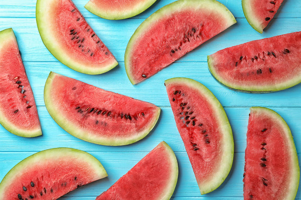 Flat lay composition with slices of watermelon on wooden background - Foto, Bild
