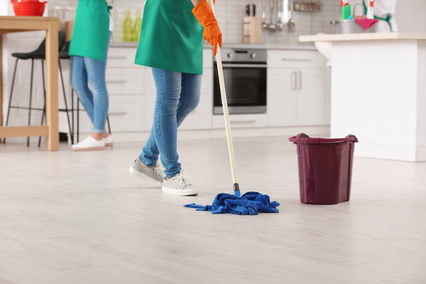 Woman cleaning floor with mop in kitchen, closeup - Fotoğraf, Görsel