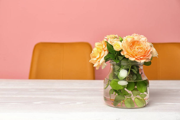 Vase with blooming flowers on table indoors - Fotoğraf, Görsel