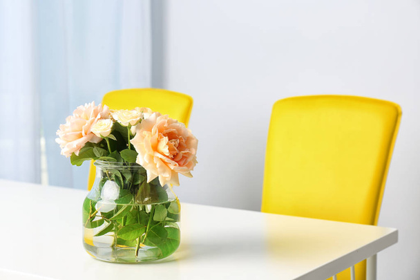 Vase with blooming flowers on table indoors - Φωτογραφία, εικόνα