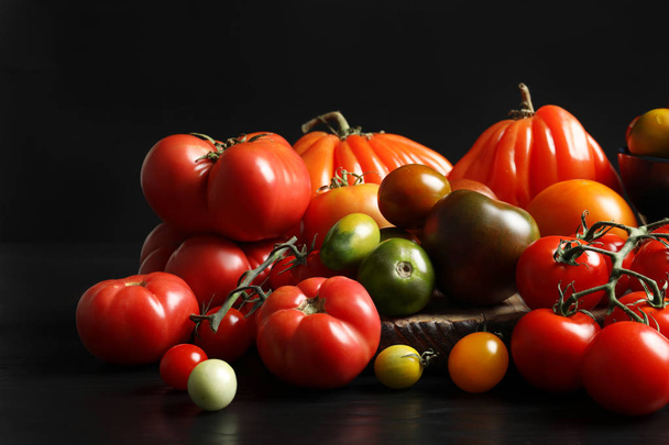 Composition with tasty juicy tomatoes on table - Foto, afbeelding