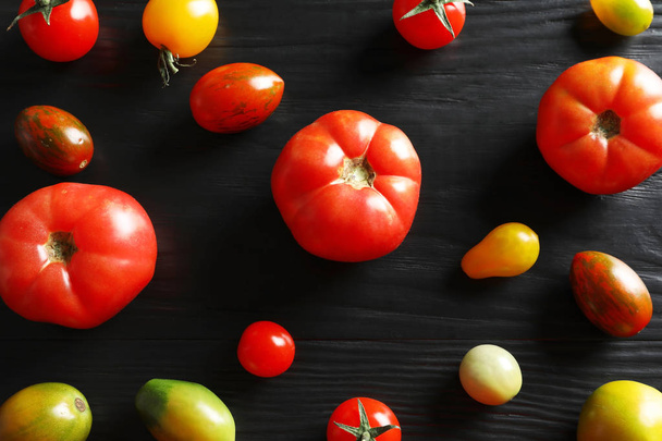 Flat lay composition with juicy tomatoes on wooden background - Фото, изображение