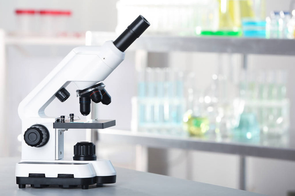 Modern microscope on table in laboratory. Chemical analysis - Zdjęcie, obraz