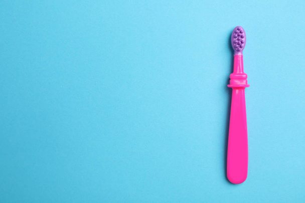 Manual toothbrush for child on color background, top view with space for text - Valokuva, kuva