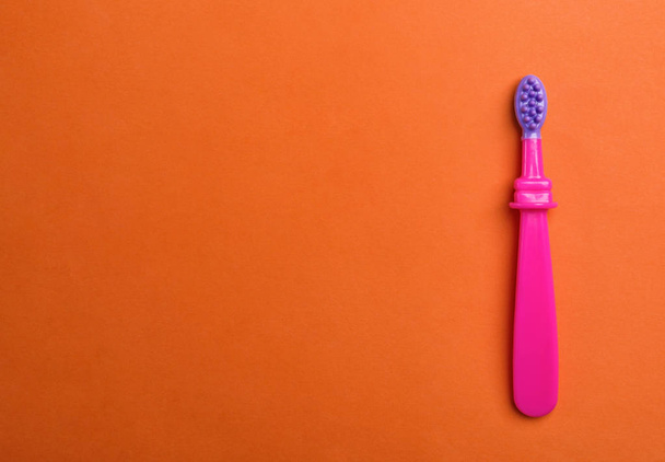Manual toothbrush for child on color background, top view with space for text - Foto, Bild