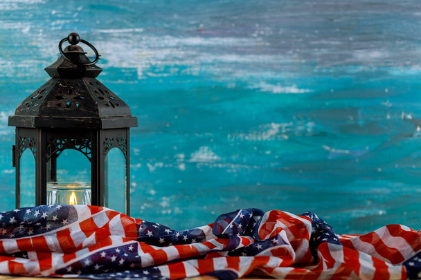 brennende Kerze mit einer alten amerikanischen Flagge, türkisfarbener Hintergrund - Foto, Bild
