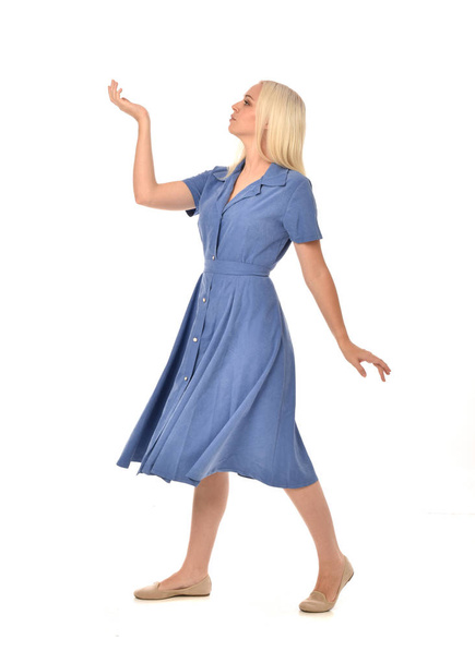 full length portrait of blonde girl wearing blue dress, standing pose. isolated on white  studio background. - Фото, изображение