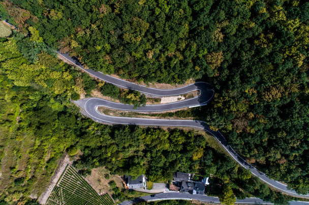 Winding road serpentine from a high mountain pass in the mosel village Brodenbach Germany Aerial view - Fotó, kép