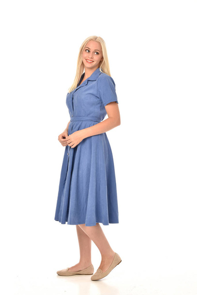 full length portrait of blonde girl wearing blue dress, standing pose. isolated on white  studio background. - Photo, Image