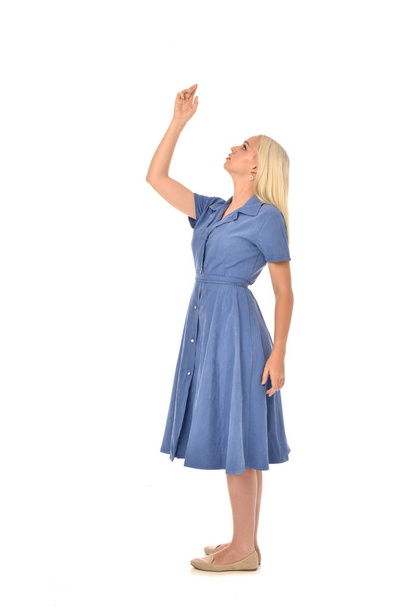 full length portrait of blonde girl wearing blue dress, standing pose. isolated on white  studio background. - Fotoğraf, Görsel