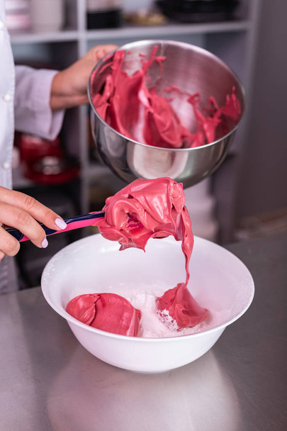 Confectioner mixing pink and white meringue in big bowl - Fotoğraf, Görsel