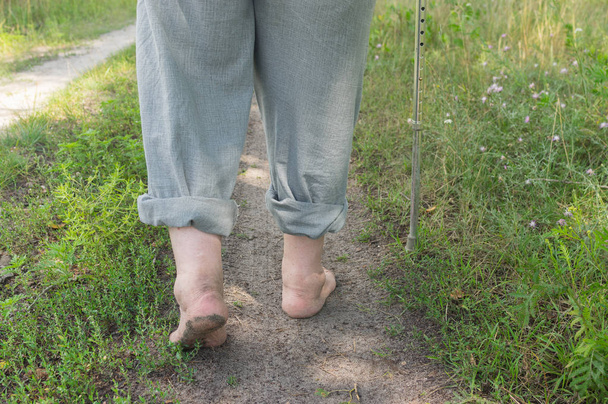 Чоловік ходить по земній дорозі босоніж
 - Фото, зображення