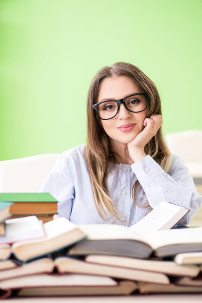 Young female student preparing for exams with many books  - Φωτογραφία, εικόνα