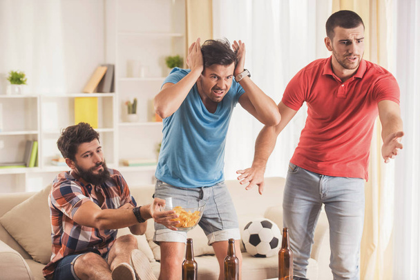 Upset Men with Beer Watching Football at Home. - Foto, Imagen