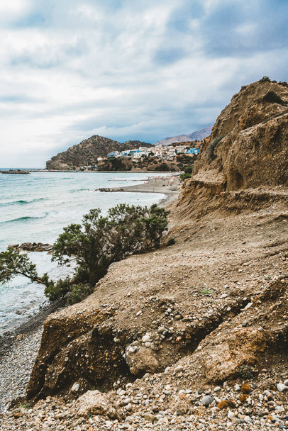 Crete, Greece. beach with rocks and cliffs with view towards sea ovean on a sunny day. - 写真・画像