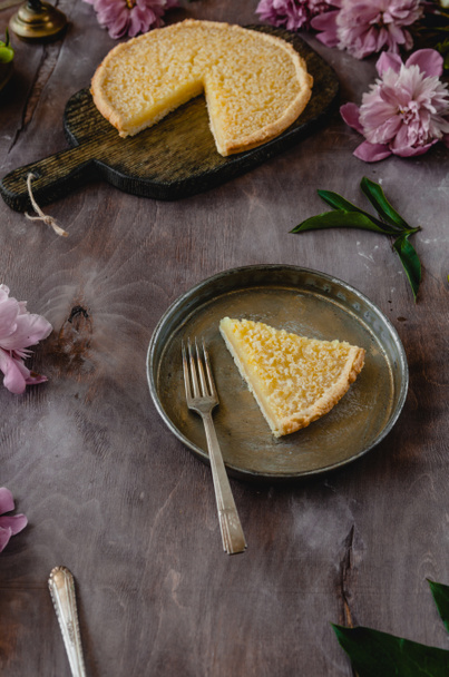 piece of tasty lemon pie on plate on wooden table - Photo, Image