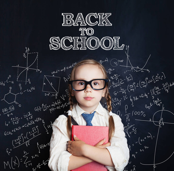 Smart child girl in glasses on chalk board background. Back to school concept - Foto, Bild