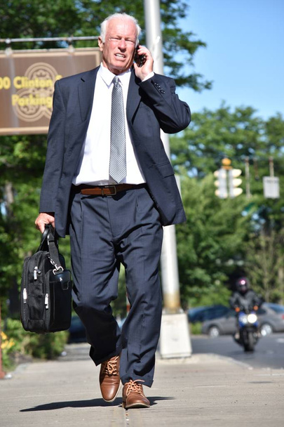 Businessman Using Cell Phone Walking - Фото, изображение