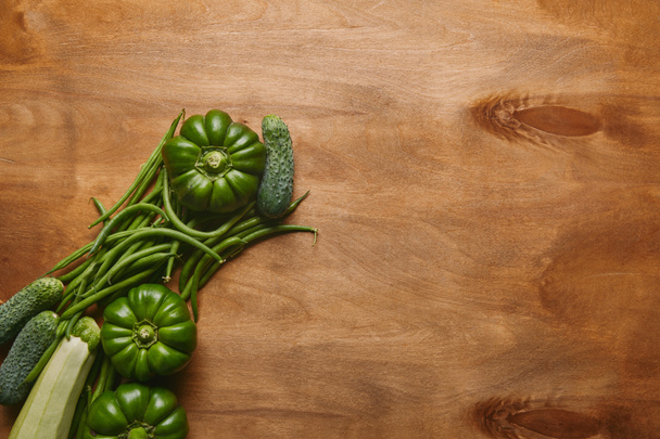 Bell peppers and green beans on wooden table - 写真・画像