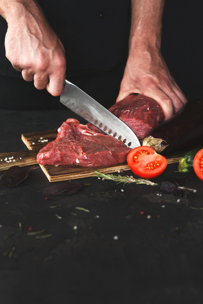 Chef cutting filet mignon on wooden board - Photo, Image