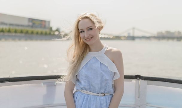 Young woman enjoy a boat tour through river. - Fotoğraf, Görsel