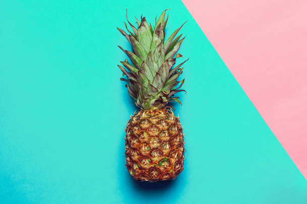 pineapple on colored paper, top view  - Photo, image