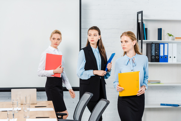 successful young businesswomen with folders of documents at modern office - Photo, Image