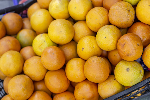 Close-up shot for multiple orange colored oranges on plastic box - Fotoğraf, Görsel