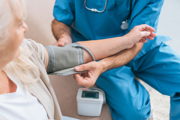 介護者の年配の女性に血圧測定のショットをトリミング - 写真・画像