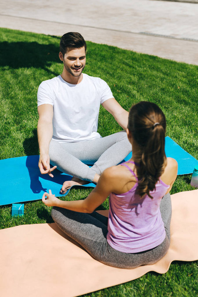 Nice handsome man looking at his yoga partner - Photo, image