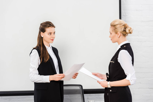 confident young businesswomen with documents at modern office - Photo, Image