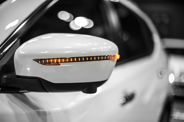 mirror of compact SUV with working turn signal, detail of car close-up - 写真・画像