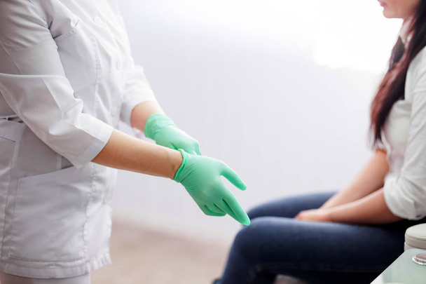 Doctor podologist wearing gloves - Photo, Image
