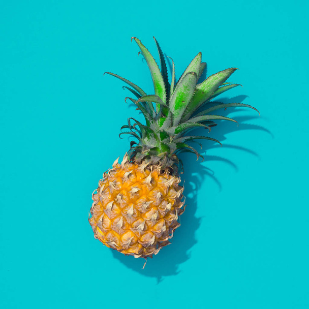 Creative tropical layout with pineapple and blue vivid paper. Abstract food art background. Minimal summer concept. Flat lay. - Photo, Image