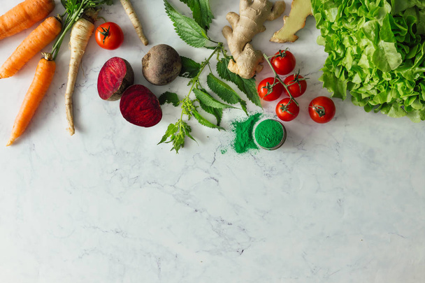 Creative food layout with fruits, vegetables and leaves on bright marble table background. Minimal healthy food concept. Flat lay. - Photo, Image
